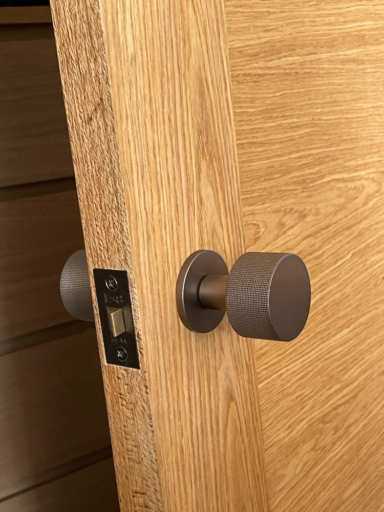 Solid oak interior door with brushed bronze handle