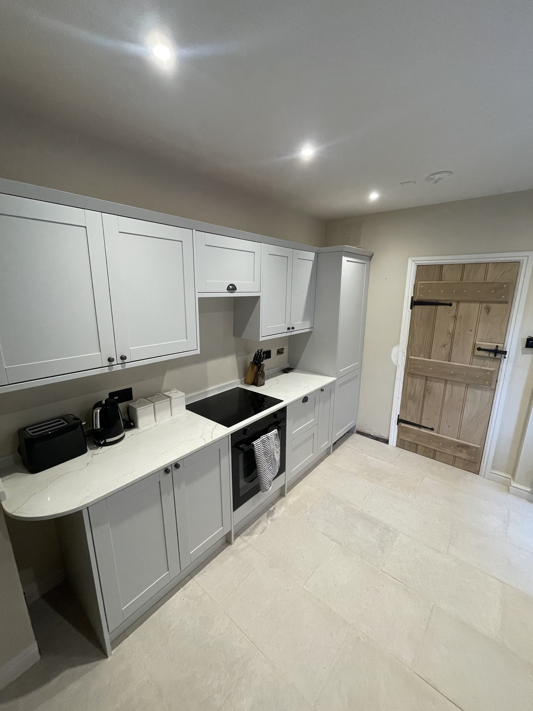 Completed kitchen renovation with fitted units and worktops